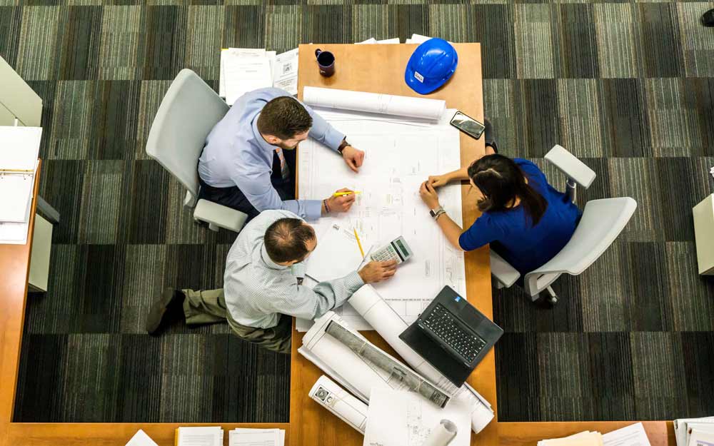 three professionals working on project management