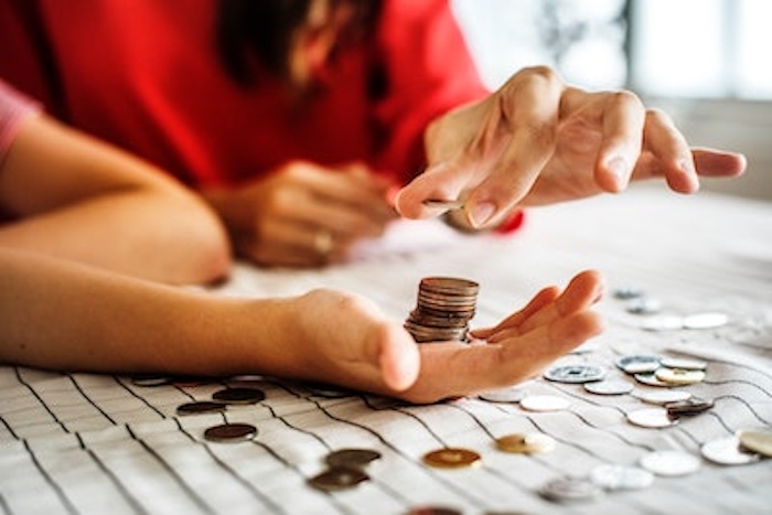 hands holding and stacking coins