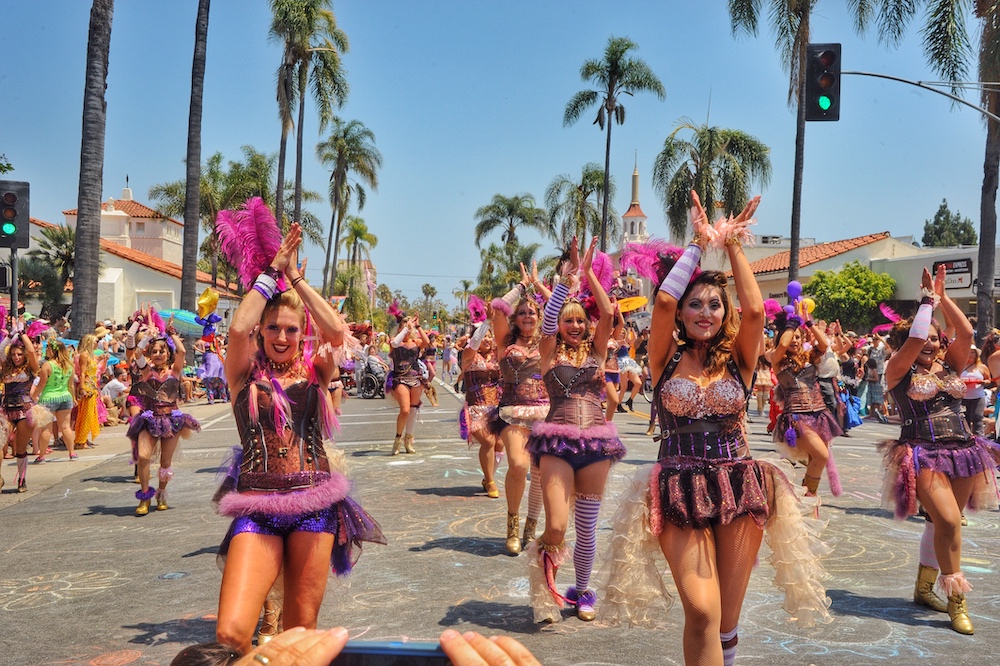 dancers on the street in a group with palm trees
